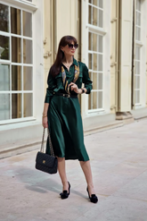 a lady in a solid green dress
